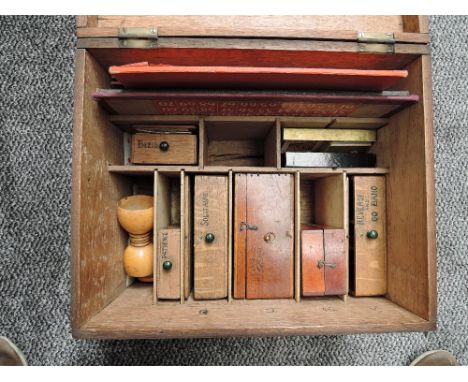 A wooden storage box containing a Compendium of Games including Chess, Solitaire Marbles include Glass Twists, Patience, Reve