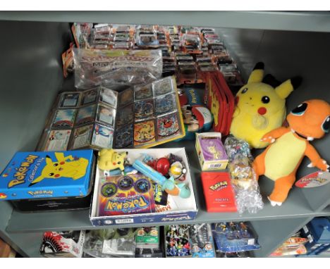 A shelf of modern Pokemon collectables including Nintendo Pikachu and Charmanda soft toys both with original tags, Tiger Poke