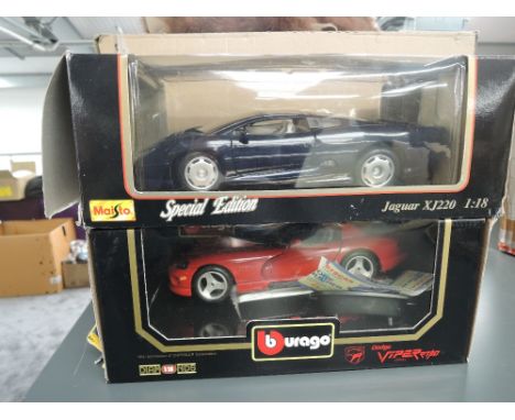 Two Maisto 1:18 scale diecasts, Special Edition Jaguar XJ220 and Dodge Viper, both in window display boxes