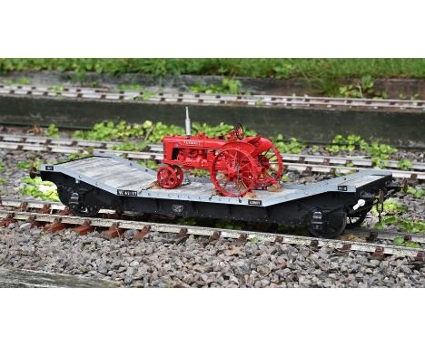A 5 inch gauge 15 ton Loriot transporting wagon No W 42197. Transporting a model of a Farmall agricultural tractor with spud 