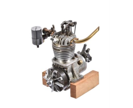 A Kiwi four-stroke model petrol engine, circa 1960, of around 14.5cc displacement with distributer/points mounted to the of t