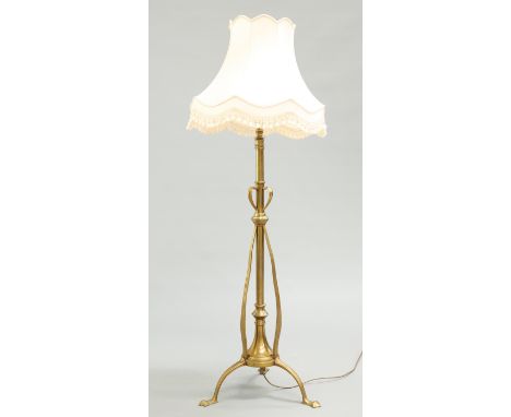 AN ART NOUVEAU BRASS TELESCOPIC STANDARD LAMP, with whiplash collar and tripod base with pointed feet. 162cm high to top of s