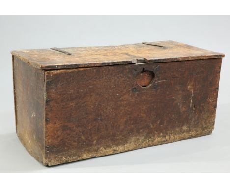A 17TH CENTURY BOARDED OAK TRUNK, the hinged rectangular top with iron strap hinges. 40cm high, 85.5cm wide, 42cm deep