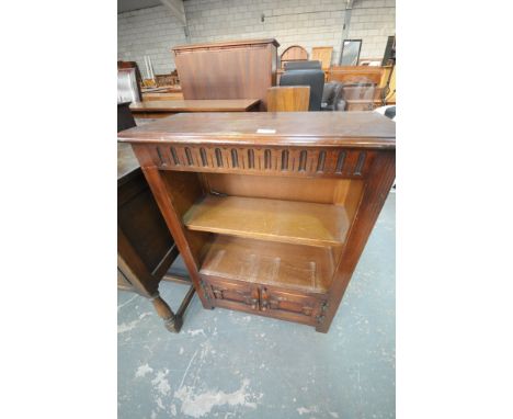 An Oak priory style bookcase with an enclosed shelf above 2 cupboard doors.