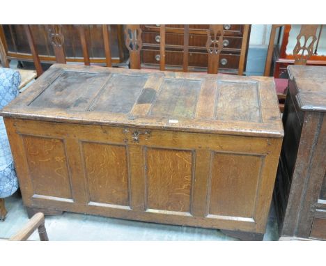 A 17th Century oak coffer
The rectangular hinged four panel top, panelled front and sides raised upon later bracket feet. 66x