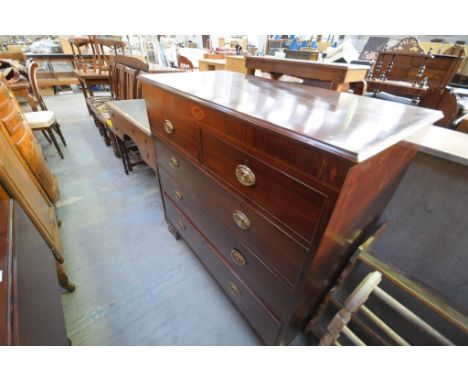 An Early 19th century mahogany chest of drawers the plain frieze centred with an inlaid conch shell above 2 short and 3 long 
