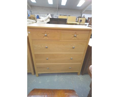 A Modern light oak chest of 2 short and 3 long drawers with brushed metal button handles.