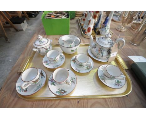 A 19th Century earthenware  tea service decorated with birds comprising  teapot, sugar basin , slop bowl, cream jug and 5 cup