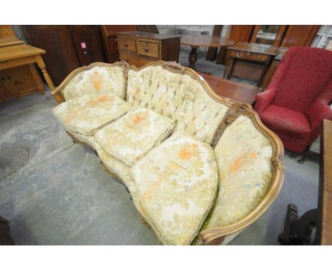 A 20th century French walnut serpentine settee with a button back , cabriole front legs with a carved apron.