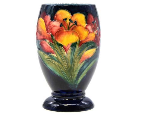 Walter Moorcroft for Moorcroft, a vase in the Freesia design, circa 1950, yellow and red flowers on a dark blue ground, green