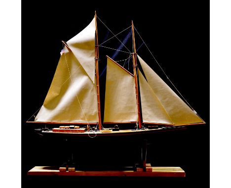 Hand built wooden scale model pond yacht of a schooner, height 114cm, on a wooden stand.