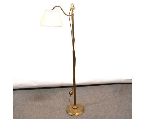 Floorstanding brass standard lamp, the head supported on a scrolled arm, circular domed base, 148cm.