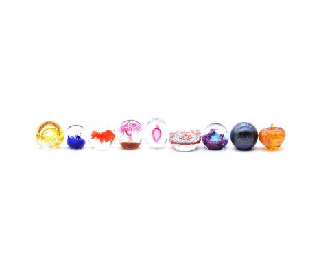 Collection of nine paperweights including Caithness, and an oval crystal glass tray, 26cm.