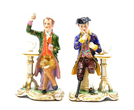 Royal Crown Derby, a pair of seated Greenwich Pensioner figures, one of a sailor in tricorn hat with wooden leg, the other of