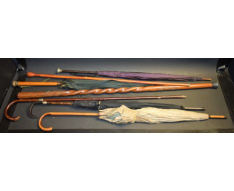 An owl head walking stick; two others; four umbrellas (7)