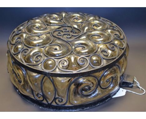 An ornate wrought iron and glass light fitting