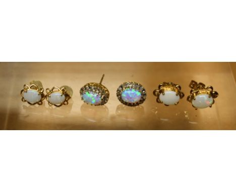 A pair of yellow metal and white stone set stud earrings; a pair of opal earrings; another, similar (3)