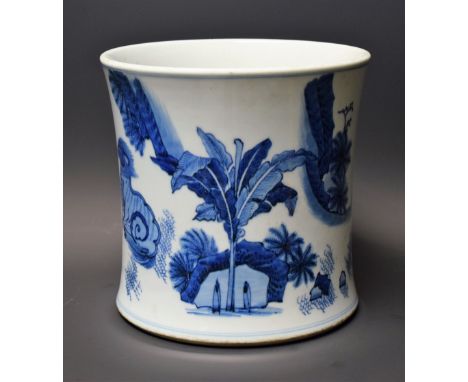 A Chinese flared cylindrical brush pot, painted in underglaze blue with mythical beasts in a landscape of prunus root, pine, 