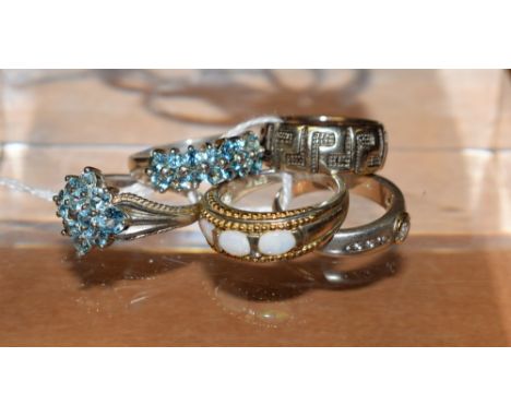 A sterling silver ring set with polished opal cabochon stones, marked 925; four other sterling silver dress rings, some with 