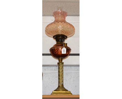 A late Victorian copper and brass oil lamp, fluted apricot shade, approx overall height 70cm