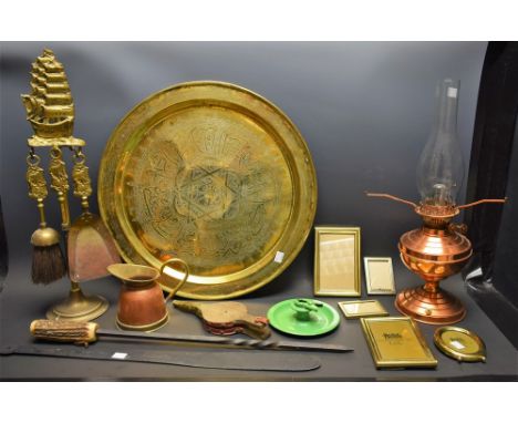 A copper lamp; a brass charger; a brass toasting fork; a brass companion set; other metalware; bellows; poker; enamel chamber