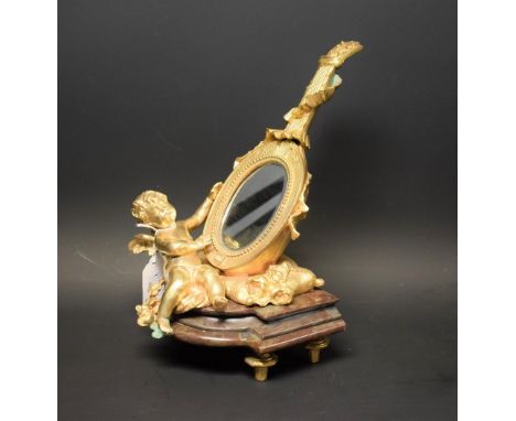 A gilt metal mantel mirror, cherub supporting lyre, on stepped marble base, approx 30cm high