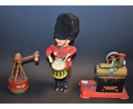 A late 1950's German clockwork drummer boy; a mid 20th century Triang camel; a Mamod stationary engine