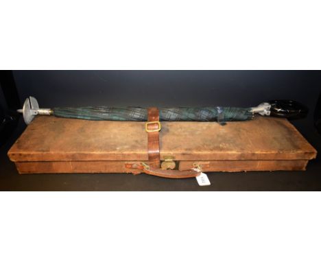 A canvas shotgun case; a combined shooting stick umbrella 