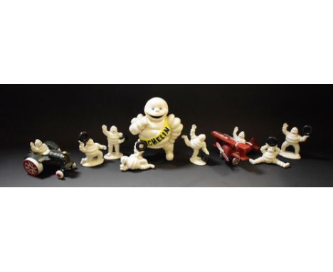 A cast metal Michelin plane and pilot; another, Michelin tractor and driver; other cast metal Michelin Man figures (9)  