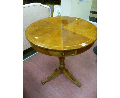 An early 19th Century drum type tripod table with circular segmented top and box wood line inlay, four opening drawers, turne