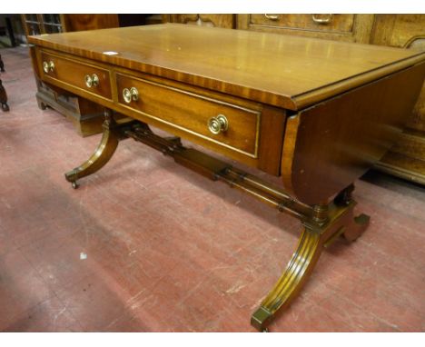 A quality reproduction mahogany sofa table, 56 x 102 cms closed (some staining to top)