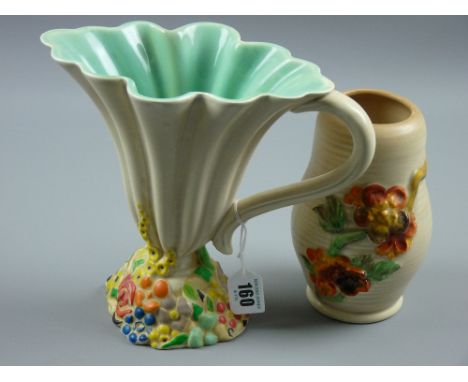 A Clarice Cliff My Garden decorated fluted jug and a Newport pottery ribbed vase with floral relief decoration, 19.5 cms and 