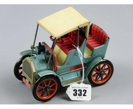 A lever driven tinplate model of a vintage car, blue, cream and red livery with spoke wheels, MT maker's mark to the rear 'Ma