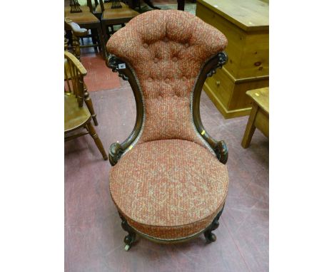 A well shaped Victorian walnut spoonback chair, button upholstered waisted back with circular seat on brass and pot castors