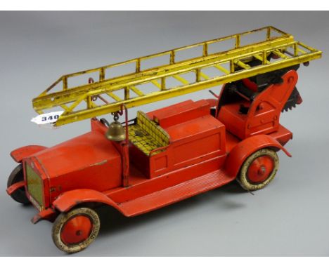 An early Johan Distler tinplate clockwork fire engine, reg. no. J.D.3701 with lithograph tinplate balloon tyres, 18 cms high,