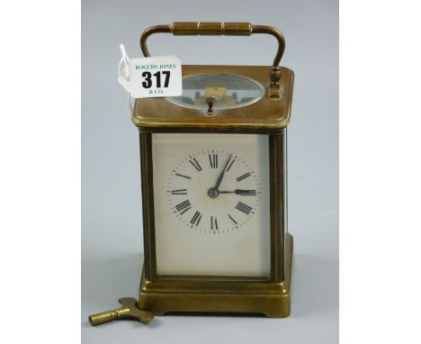 A brass cased repeater carriage clock, late 19th/early 20th Century, black Roman numerals on a white enamel dial, platform le