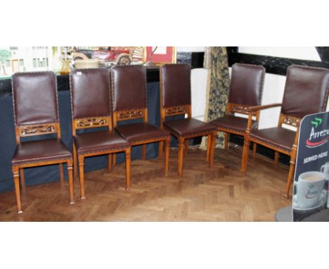 Set of six light oak dining chairs with carving to back and studded upholstery on tapered legs