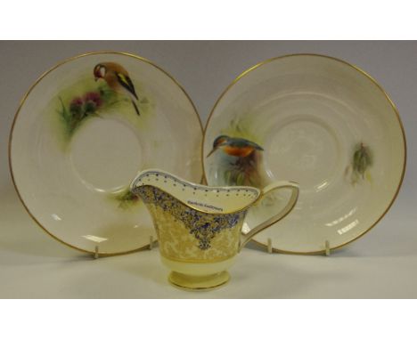 A Royal Worcester cabinet plate hand painted with a Goldfinch amongst thistles by D. Jones, signed, printed marks to base; an