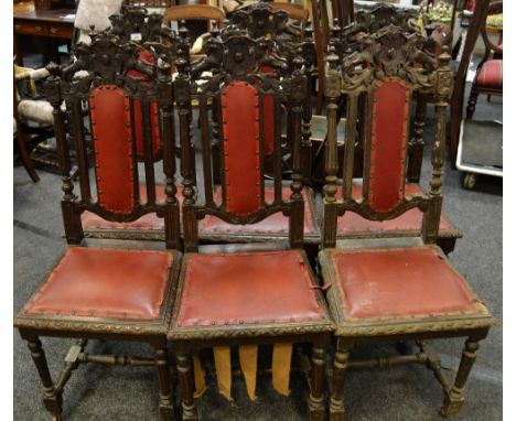 Six oak Carolean style dining chairs, carved top rails, padded back, turned and fluted uprights, padded seat, turned legs and