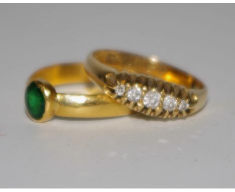 An 18ct gold diamond ring set with five claw set diamonds, approx. diamond weight 20pts, 3.3g; another gold coloured emerald 