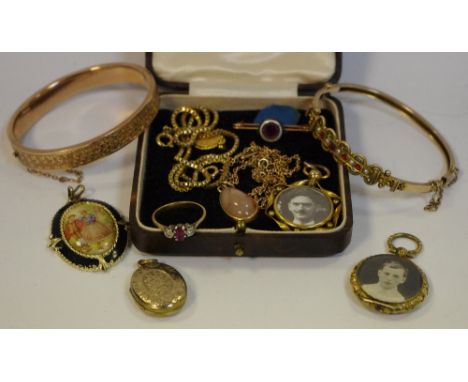 A Victorian yellow coloured metal bangle set with seed pearls and red coloured stones; another; a yellow coloured metal trilo