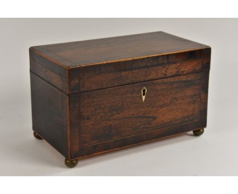 A George III crossbanded rosewood rectangular tea caddy, hinged cover enclosing a pair of tin canisters, outlined throughout 