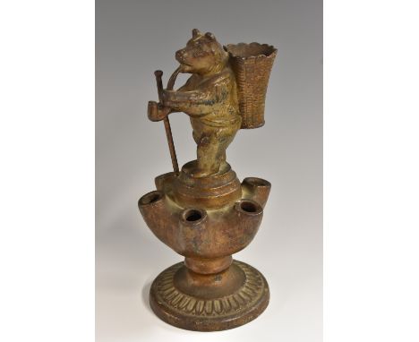 A 19th century cast iron novelty pipe stand/vesta, as a bear, he stands, smoking a pipe and grasping his walking staff, a wic