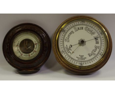 Barometers - a late 19th century/early 20th century oak cased aneroid barometer; another mahogany  
