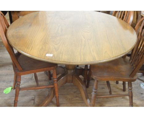 An Oak tripod circular dining table