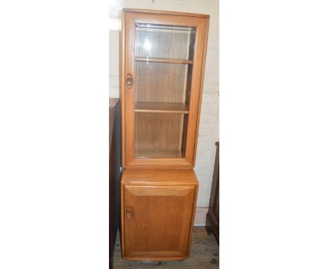 A light Ercol glazed display cabinet 