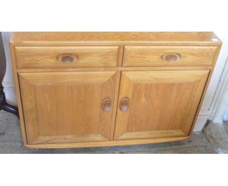 A light Ercol two drawer, two door sideboard
