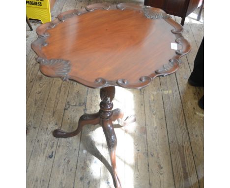 A reproduction Mahogany pie crust tripod table