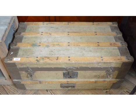 A metal and wood bound canvas trunk