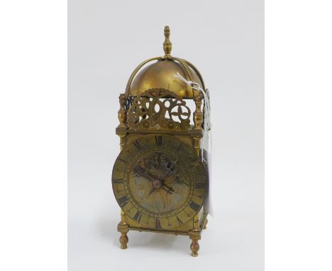 Brass lantern clock of typical form with domed top and Roman numerals, 26cm high 